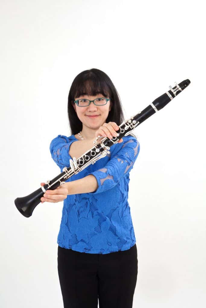 Picture of Anna Hashimoto holding out a clarinet