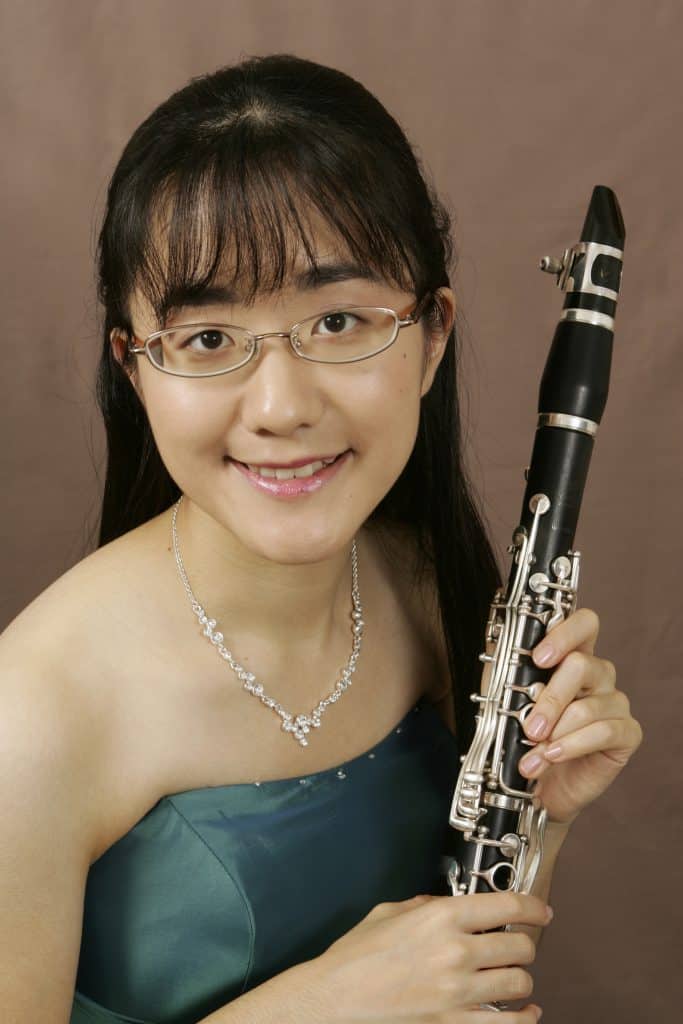 Close-up portrait of Anna Hashimoto holding a clarinet