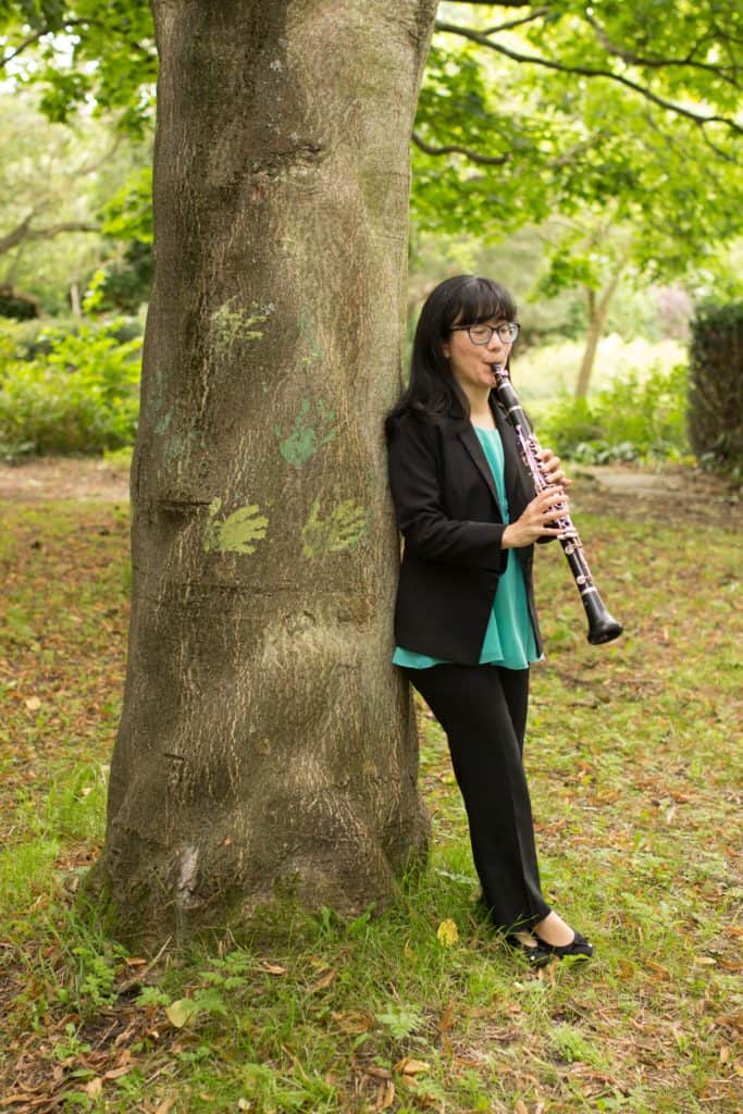 Portrait photograph of Anna Hashimoto playing the clarinet