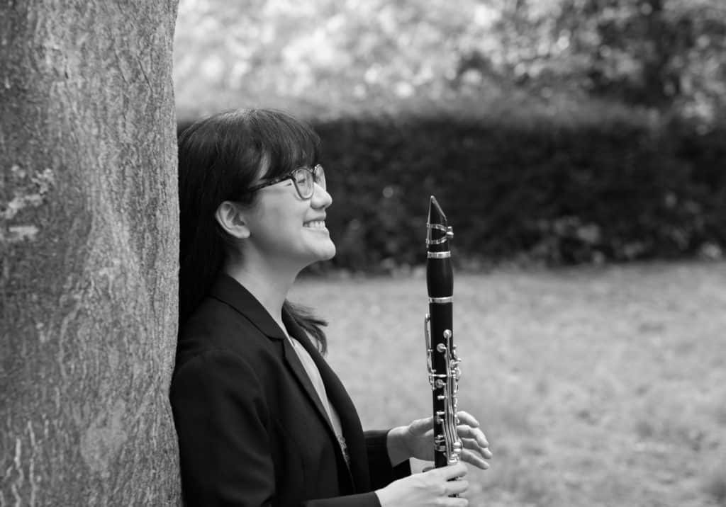 Monochrome portrait photograph of Anna Hashimoto with her clarinet
